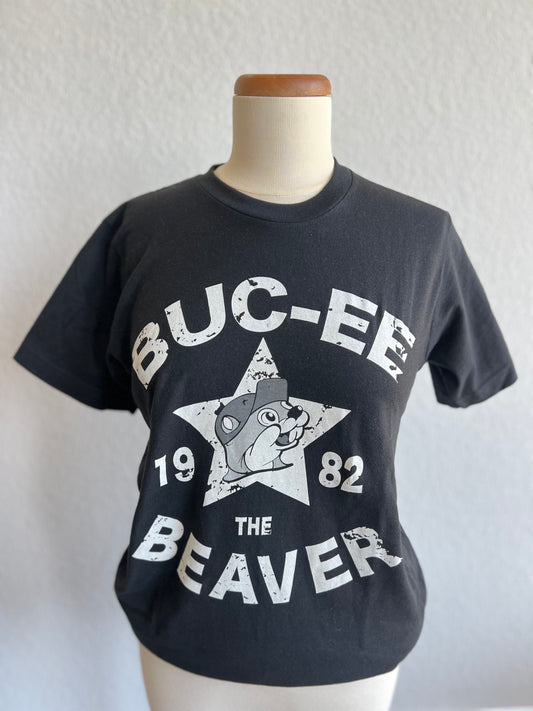 Black Bucee's T-Shirt with white lettering. Shirt has a white star in the middle with the words Buc-ee's Beaver 1982 on the front.