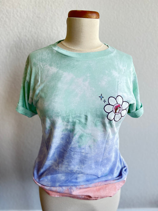 A mint, purple, pink tie dye shirt with a white flower and beaver on the left chest 