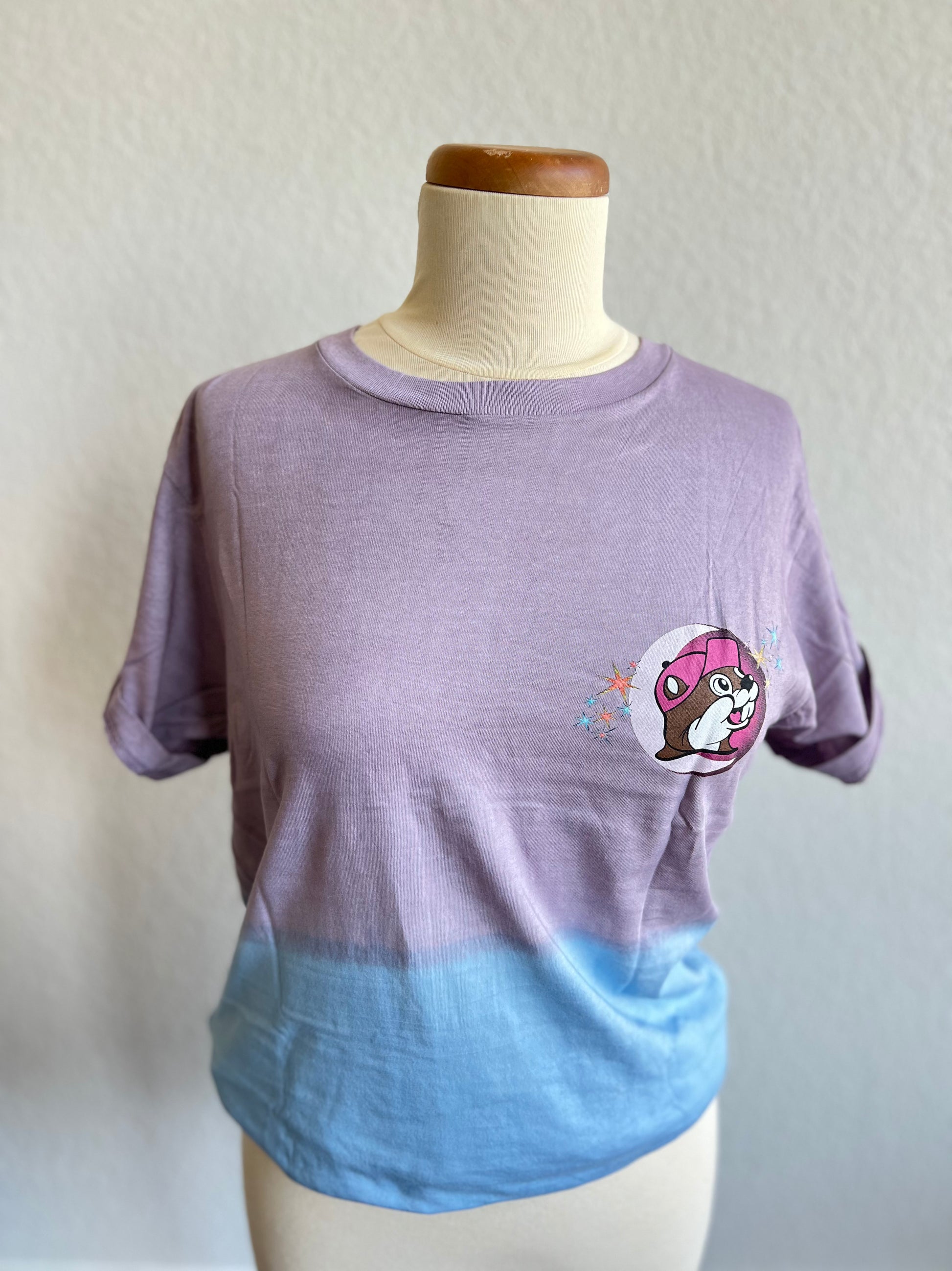 A purple and blue ombre shirt on a mannequin bust with a buc-ee's beaver on the left chest